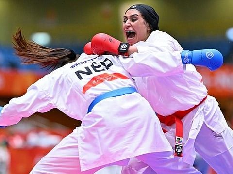 Saudi karate athlete Dina Mustafa celebrating at the Asian Games